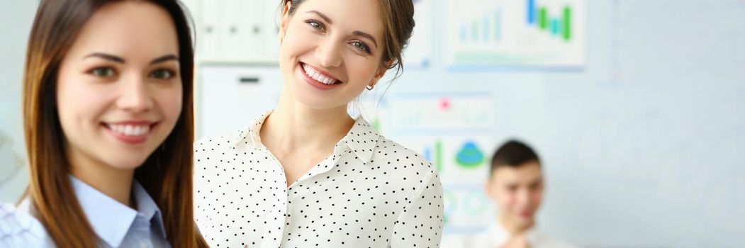 Portrait of smart female holding paper tablet with important business contract. Gorgeous lady in classy blouse looking at camera with great joy and calmness. Company meeting concept