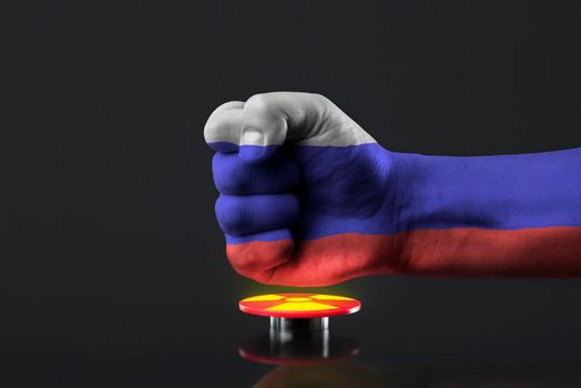 The threat of nuclear war. Russia threatens the world with nuclear weapons. A fist painted in the colors of the Russian flag presses a large red button with the symbol of a nuclear weapon