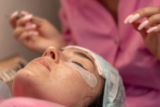 Eyelash extension procedure. Woman eye with long eyelashes. lashes, close up, macro, selective focus