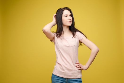 Portrait of happy fashion female with nice hairstyle and beautiful blue eyes posing at studio. Cheerful girl looking away and smiling. Isolated on dark background