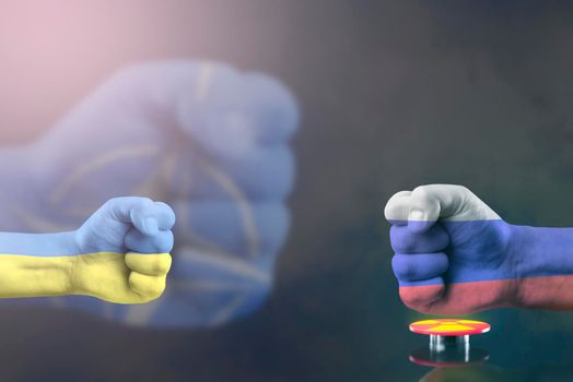 Confrontation NATO and Russia. Military conflict in Ukraine. The threat of nuclear war. NATO fist breaks a fist painted in the colors of the Russian flag. Red button with a symbol of nuclear weapons