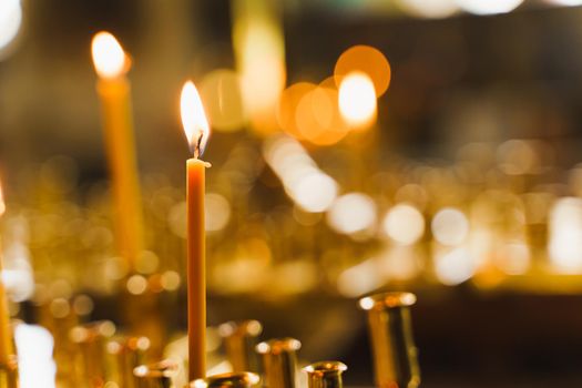 Many burning candles in church. Tragedy. Orthodox tradition and faith. Equipment for praying. Pray for people life. Pray to god