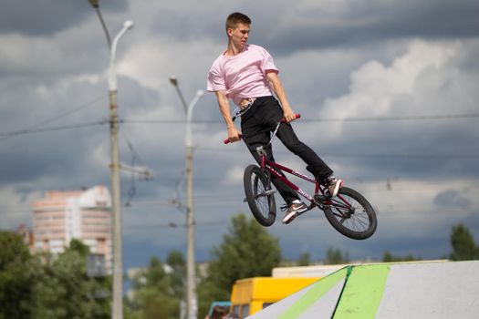 Extreme cycling.A man on an extreme bicycle against the sky. Leap into the sky