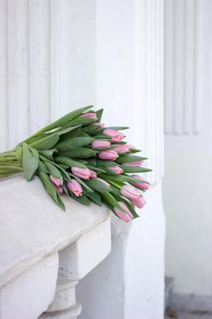 Gorgeous bouquet of tulips. Beautiful spring flowers. Gift for a girl. Arhitecture elements.