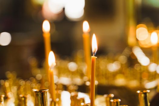 Many burning candles in church. Tragedy. Orthodox tradition and faith. Equipment for praying. Pray for people life. Pray to god