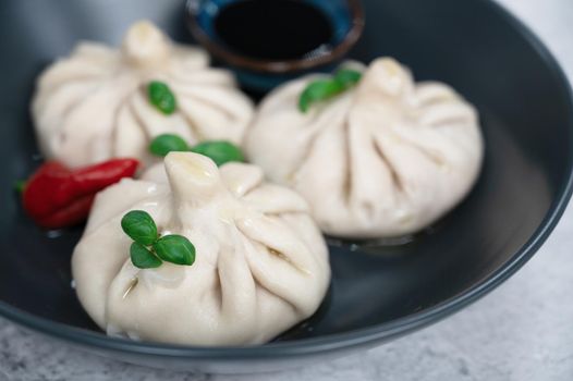 Manti on a plate. Traditional asian food stuffed with meat and vegetables