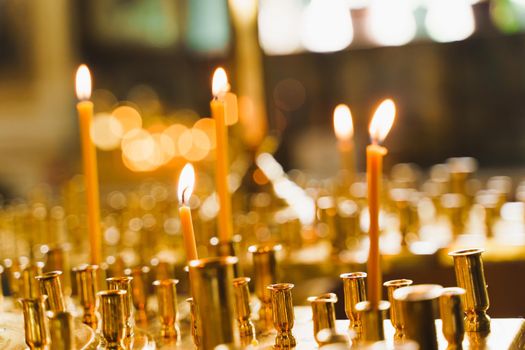 Many burning candles in church. Tragedy. Orthodox tradition and faith. Equipment for praying. Pray for people life. Pray to god