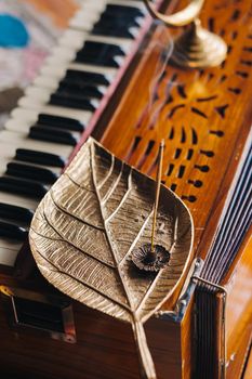 harmonium during the practice of kundalini yoga and the incense standing on it.