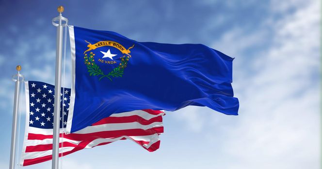 The Nevada state flag waving along with the national flag of the United States of America. In the background there is a clear sky. Nevada is a state in the Western region of the United States