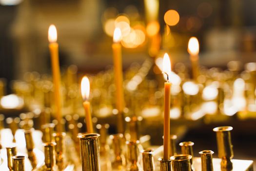 Many burning candles in church. Tragedy. Orthodox tradition and faith. Equipment for praying. Pray for people life. Pray to god