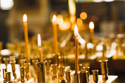 Many burning candles in church. Tragedy. Orthodox tradition and faith. Equipment for praying. Pray for people life. Pray to god