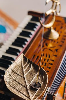 harmonium during the practice of kundalini yoga and the incense standing on it.