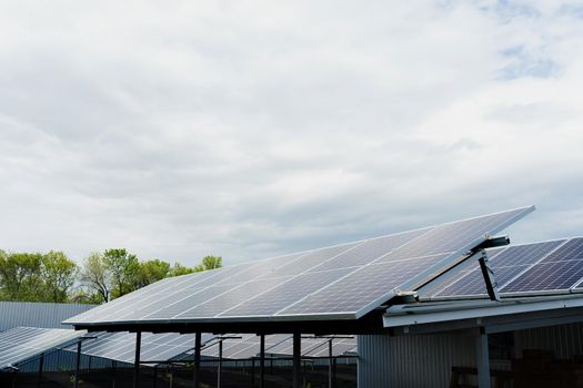 Solar panels stands in row on the roof . Free electricity for home. Sustainability of planet. Green energy. Solar cells power plant business