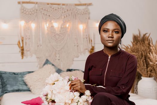 Muslim girl with bouquet of flowers from her boyfriend on the valentines day. Holiday celebration