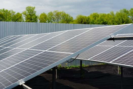 Solar cells closeup. Alternative solar panels power plant. Sustainability of planet. Green energy for home. Sun blue electric modules stands in row.