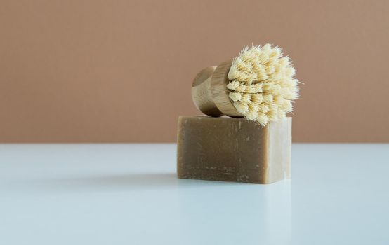 zero waste bamboo brush with soap for dishwashing in minimalistic style. High quality photo