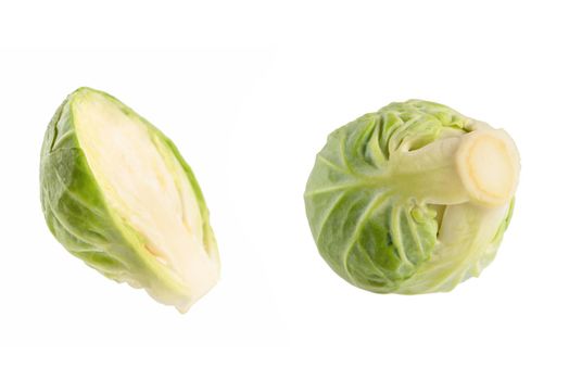 Fresh green Brussels sprouts on a white background. Brussels sprouts cut in half casts a shadow on white isolate.