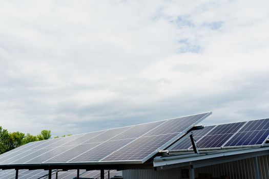 Solar panels stands in row on the roof . Free electricity for home. Sustainability of planet. Green energy. Solar cells power plant business