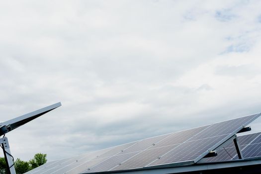 Solar panels stands in row on the roof . Free electricity for home. Sustainability of planet. Green energy. Solar cells power plant business