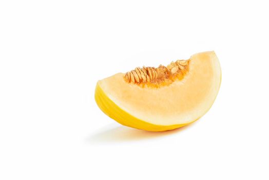 Melon on a white background. Yellow melon on a white isolate. Fresh juicy piece of melon with shadow on a white background. For insertion into a project, design or advertisement.