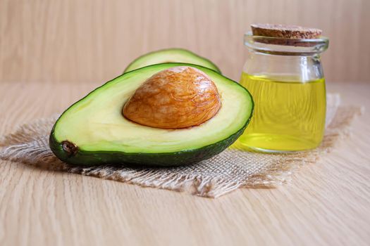 Avocado and avocado oil on wooden background. Selective focus.food