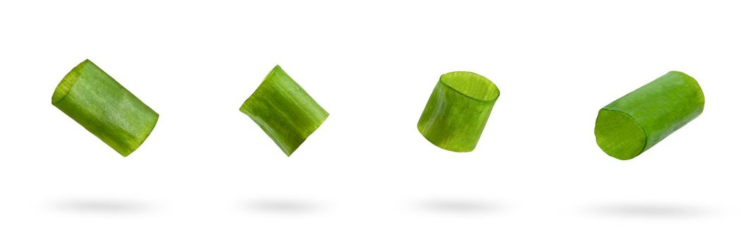 Set sliced green onion on a white background. Green onion slices fall or fly, casting a shadow.