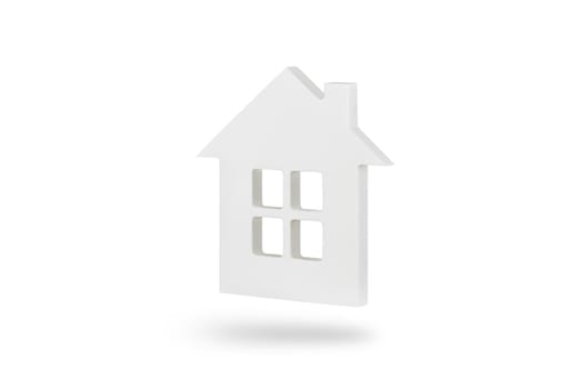 House model isolated on white background. A white isolated house with a window casts a shadow on a white background. To insert into a project or template.