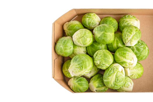 Paper packaging of Brussels sprouts on a white background, close-up. Isolate of environmentally friendly packaging of vegetables with place for text