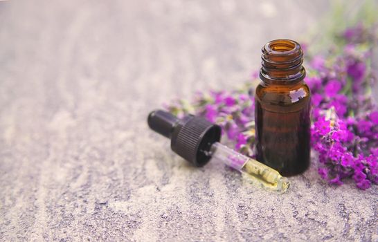 Lavender essential oil in a small bottle. Selective focus. nature.