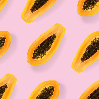 Fresh ripe papaya seamless pattern on pink background. Tropical abstract background. Top view. Creative design, minimal flat lay concept. Trend tropical fruit food background pattern