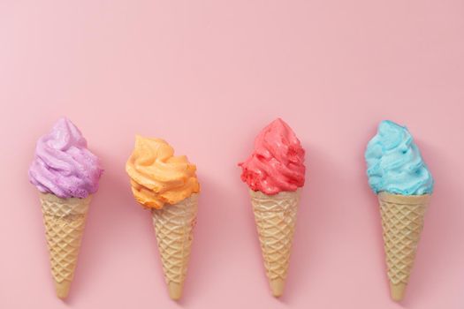 Various of colourful meringue ice cream cone on pink background for sweet and refreshing dessert concept