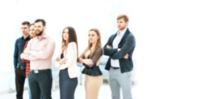 blurred image for the advertising text. confident business team standing in the office.