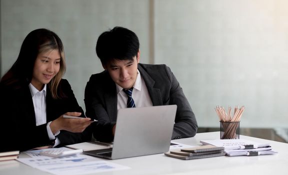 Fund managers team consultation and discuss about analysis Investment stock market by laptop..