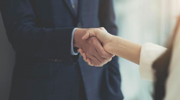 Close up of Business people shaking hands, finishing up meeting, business etiquette, congratulation, merger and acquisition concept.