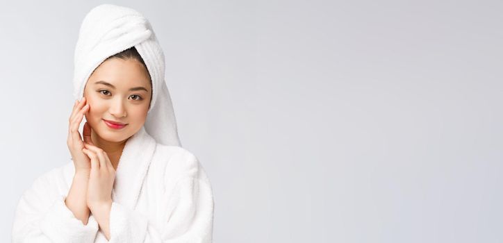 Spa skincare beauty Asian woman drying hair with towel on head after shower treatment. Beautiful multiracial young girl touching soft skin