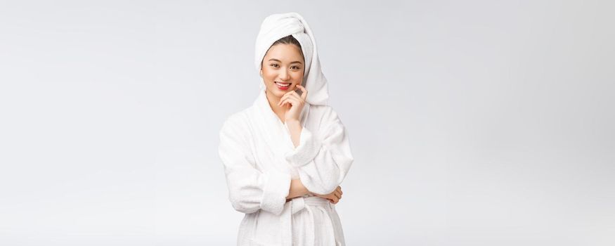 Spa skincare beauty Asian woman drying hair with towel on head after shower treatment. Beautiful multiracial young girl touching soft skin.