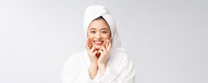 Spa skincare beauty Asian woman drying hair with towel on head after shower treatment. Beautiful multiracial young girl touching soft skin.