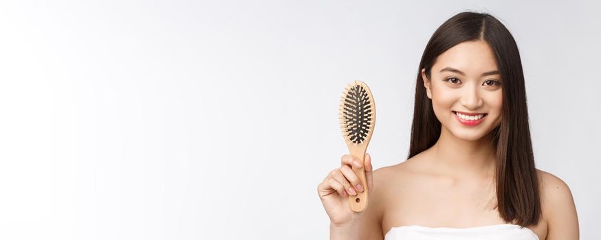 portrait of a beautiful young woman comb wonderful hair isolated on white background, asian beauty.