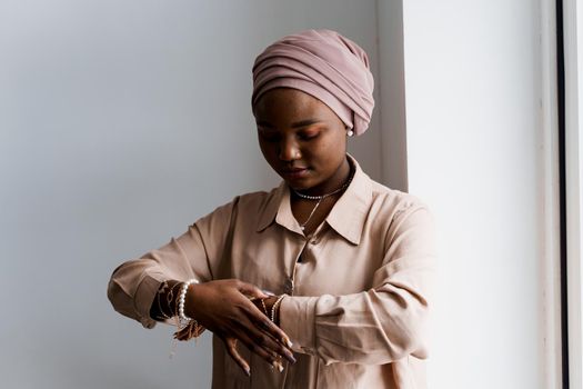Muslim black girl on white background. African business woman in studio. Model posing. Advert for banking and islamic social media