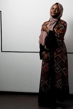 Black girl weared hijab smile and rejoise on white background. Muslim happy woman posing in studio. Attractive african female.