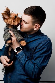 Man loves his dog yorkshire terrier. Loving animals. Advert for veterinarian and vet pharmacy