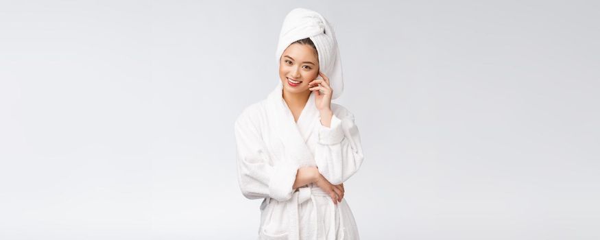 Portrait of a young happy asian lady in bathrobe.Isolated in white background