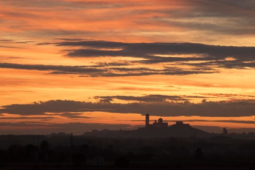 Landscape showing the silhouette of La Seu Vella tourist Cathedral in Lleida in the evening under a cloudy sky