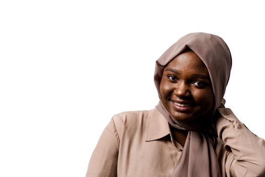 Happy and funny black girl on white background. Young muslim woman smiling in studio. Advert for social network.