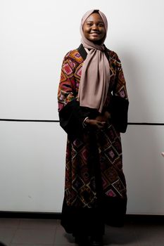 Black girl weared hijab smile and rejoise on white background. Muslim happy woman posing in studio. Attractive african female.