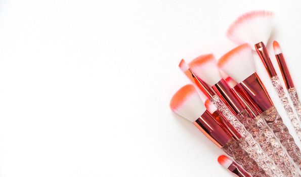 Makeup brushes on a white background. Selective focus.