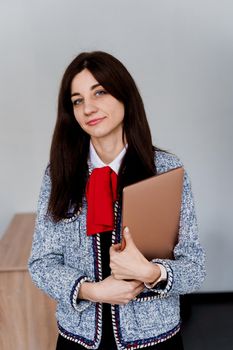 Teacher with laptop on white background. . Foreign school private study with a school girl. Teacher explain grammar of native language using laptop.