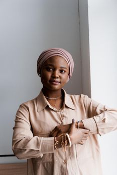 Muslim black girl on white background. African business woman in studio. Model posing. Advert for banking and islamic social media