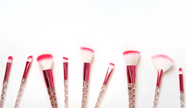 Makeup brushes on a white background. Selective focus.