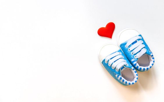 baby booties and heart isolate on a white background. Selective focus.